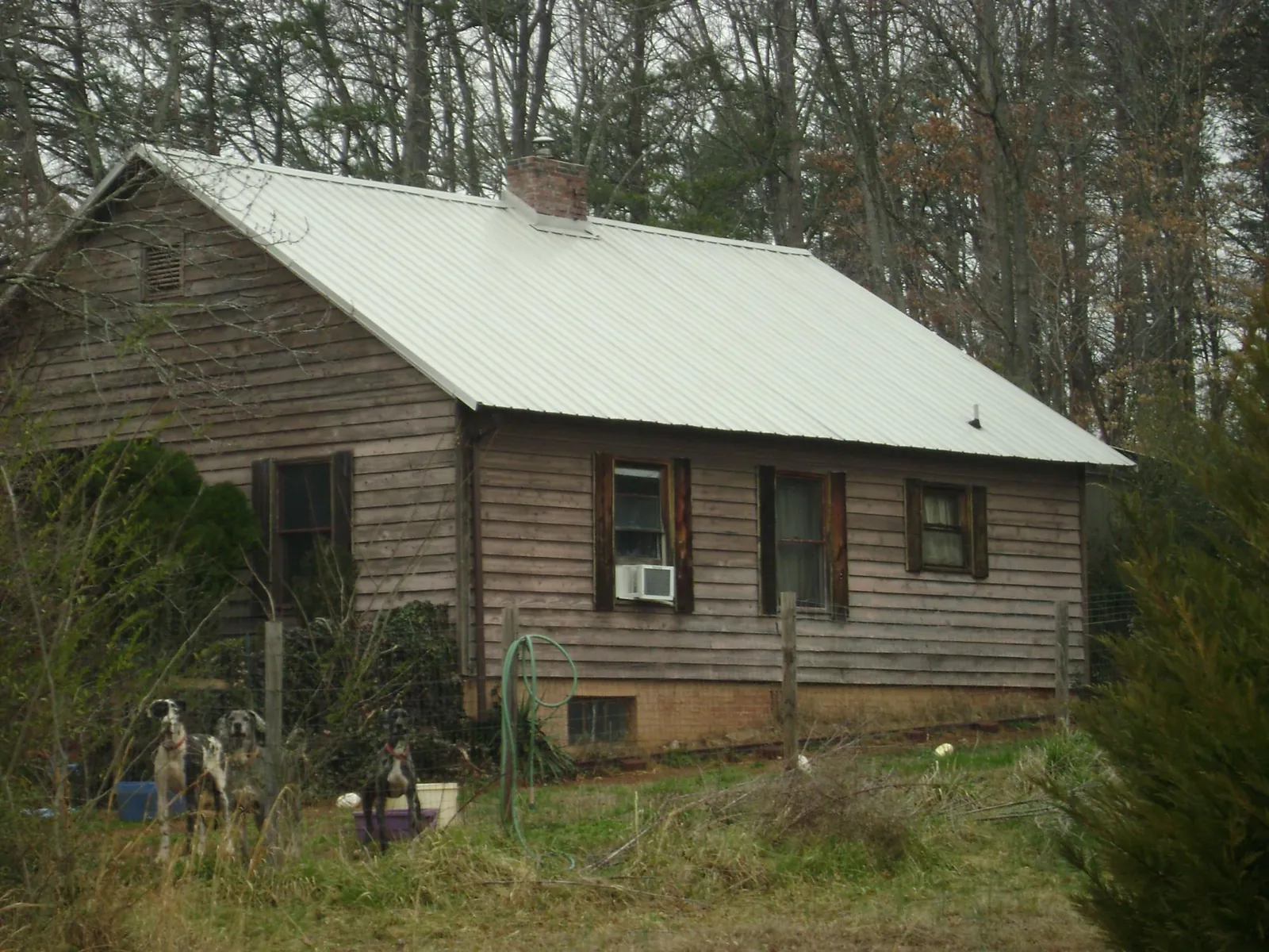 White metal roof on an old wood sided farmhouse, from a Metal Roof Installation job in Fairbury